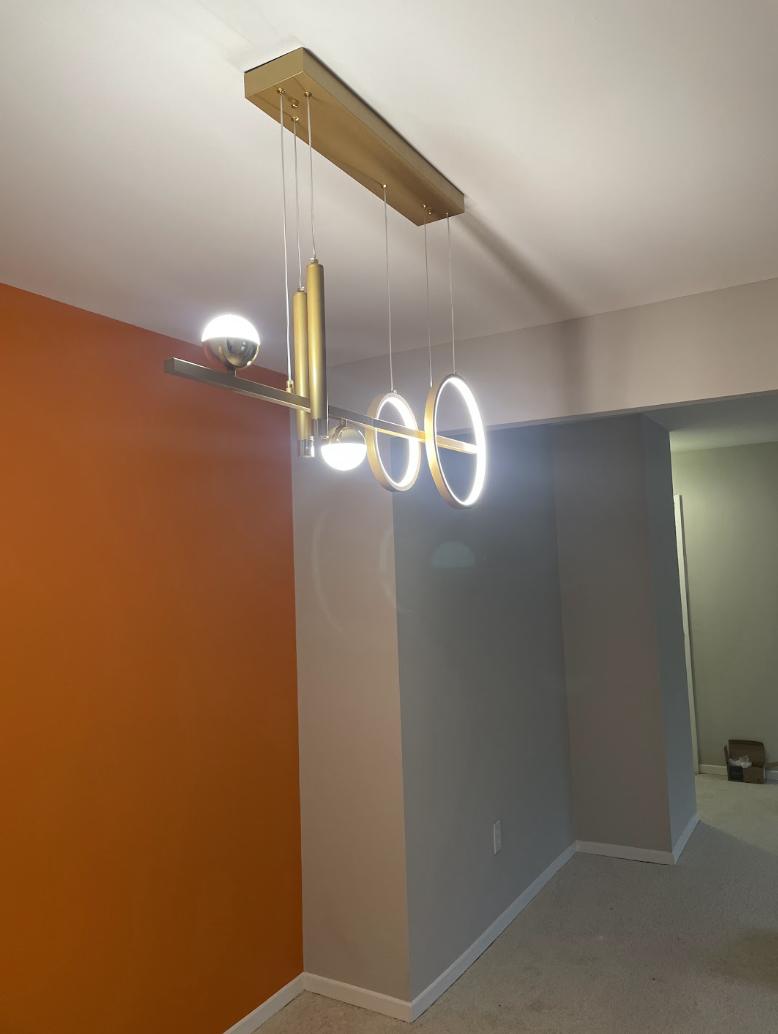 Orange and grey painted walls with a brass ring pendant light